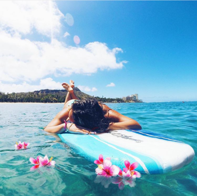 women laying on surfboard