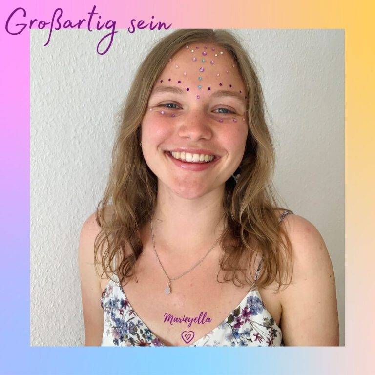 Marieyella looking at the camera smiling with a rainbow face